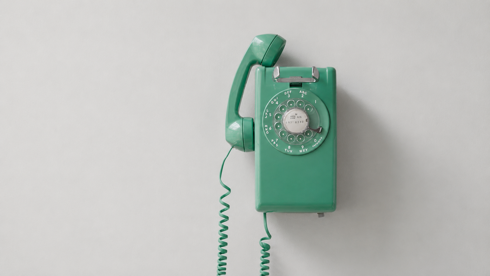 Vintage green rotary phone symbolizing outdated construction marketing built on referrals and luck